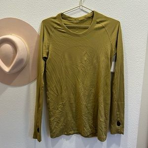 Olive green Lululemon workout top with thumb holes